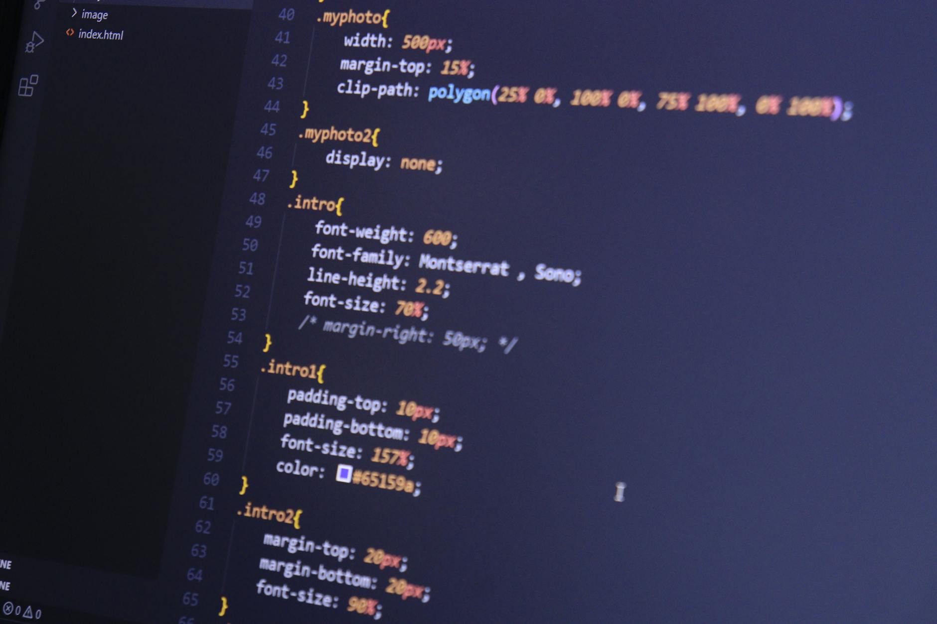 Focused shot of HTML and CSS code on a monitor for web development.
